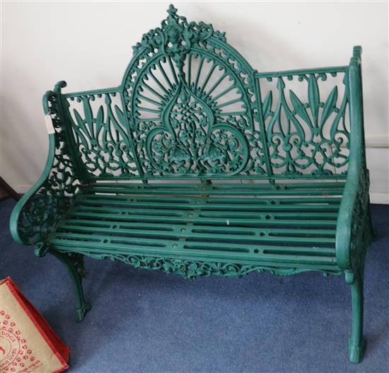 A Coalbrookdale Arabesque pattern cast iron green painted garden bench, W.122cm